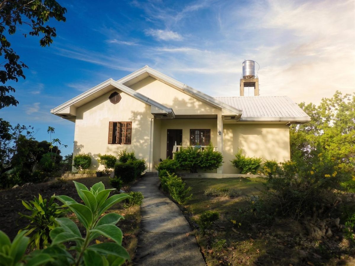Front view of the simple single-storey house on Nici Island at golden hour